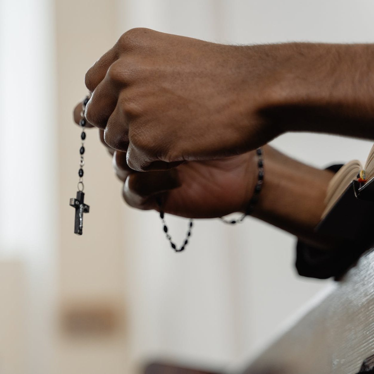 hands holding a rosary 